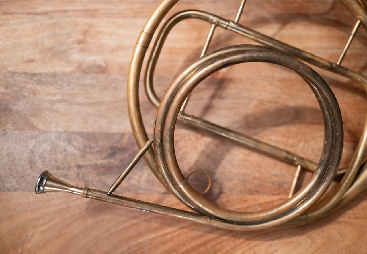 A strachan brass model h shown in the crook of a Raoux Millereau natural horn